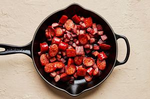 andouille and hot louisiana sausage, being cooked in a skillet
