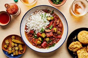 a bowl of homemade red beans rice made with andouille and hot louisiana sausage and ham hock served with cornbread