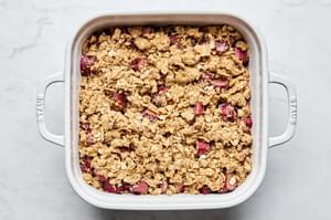 rhubarb crisp made with butter, flour, brown sugar, oats, cinnamon, nutmeg, sugar, lemon juice and mint ready for the oven