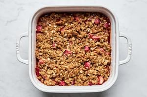 homemade rhubarb crisp made with butter, flour, brown sugar, oats, cinnamon, nutmeg, sugar, lemon juice and mint