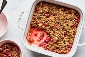 homemade rhubarb crisp being spooned into serving bowls