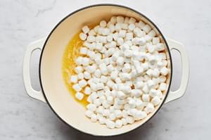 mini marshmallows being cooked in melted butter in a large pot
