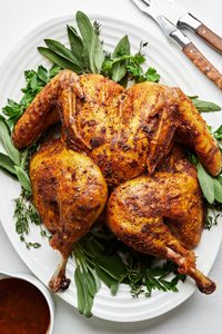 A Roast Spatchcocked Turkey seasoned with sage and thyme. A juicer faster way to cook your thanksgiving turkey.