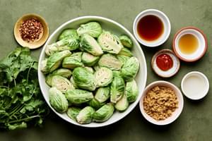 brussels sprouts, fish sauce, brown sugar, sriracha, red pepper flakes, sesame oi, rice vinegar, cilantro and min in bowls