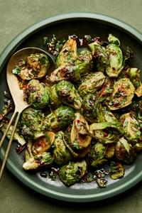 Roasted Brussels Sprouts with Sweet Fish Sauce Dressing and tossed with cilantro and mint in a serving bowl
