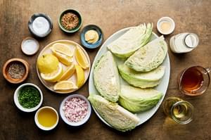 ingredients for roasted cabbage with mustard cream sauce laid out in bowls: olive oil, spices, shallot, mustard & cream