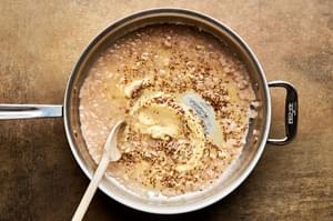 mustard cream sauce being made in a pan with shallot, white wine, whole grain mustard, dijon, and chicken stock