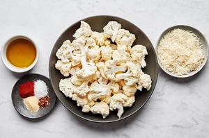 raw cauliflower florets, olive oil, salt, garlic powder, smoked paprika, red pepper flakes, and Parmesan in prep bowls