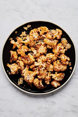 roasted cauliflower seasoned with olive oil, salt, garlic powder, smoked paprika, red pepper flakes, and Parmesan