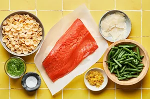 salmon filet, green beans, pasta, pesto, salt, lemon zest and parmesan cheese in prep bowls