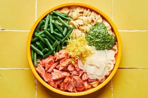 baked salmon, green beans, lemon zest, pesto, pasta and parmesan in a large bowl
