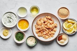salmon, onion powder, garlic powder, Old Bay seasoning, Dijon, lemon juice, chives, mayonnaise, egg & breadcrumbs in bowls