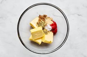 butter, tomato paste, brown sugar, garlic powder, oregano, and salt in a bowl to make compound butter