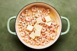 butter, garlic, garlic powder, nutmeg, salt, and pepper scallops, shrimp and cream cooking in a skillet