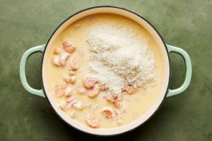butter, garlic, garlic powder, nutmeg, salt, and pepper scallops, shrimp, cream and Parmesan cooking in a skillet