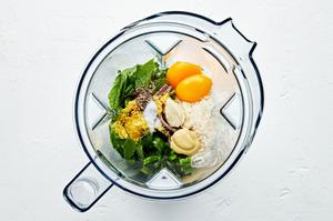 anchovies, egg yolks, lemon zest, lemon juice, garlic, mustard, serrano peppers, parmesan, mint, salt and pepper in a blender