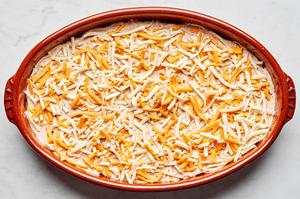 refried beans, sour cream, guacamole and shredded cheese layered in a serving bowl