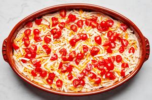 refried beans, sour cream, guacamole, shredded cheese and diced tomatoes layered in a serving bowl