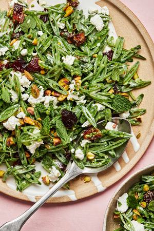shaved snap pea salad with goat cheese, dates, pistachios and mint tossed with a goat cheese dressing