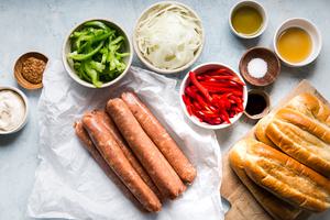 ingredients for sheet pan Italian sausage heron hoagie rolls, bell peppers, onions, honey mustard sauce