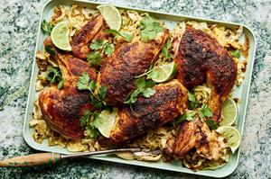 a roasted chicken cut in quarters served on top of roasted cabbage on a platter