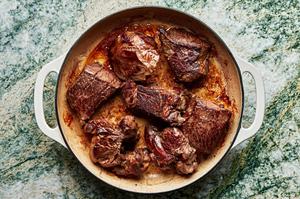 coconut milk, red curry paste, lime juice, ginger, garlic, soy sauce, fish sauce, and brown sugar in a pan with browned roast