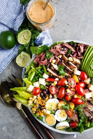 southwest cobb salad with corn, black beans, avocado , hard boiled eggs, romaine, cherry tomatoes, and pepper jack cheese