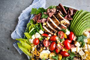 southwest cobb salad with corn, black beans, avocado , hard boiled eggs, romaine, cherry tomatoes, and pepper jack cheese