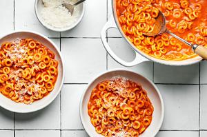 bowls of homemade spaghettiOs made with tomato paste, butter, spices, tomato sauce, chicken stock, cream and parmesan