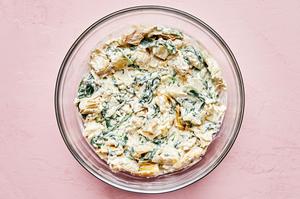 artichoke hearts, mayo, cream cheese, lemon juice, garlic powder, pepper, mozzarella and parmesan mixed together in a bowl