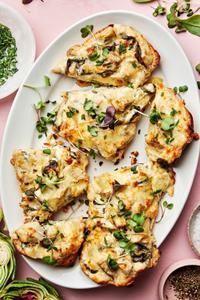 homemade spinach artichoke bread cut into slices on a serving plate