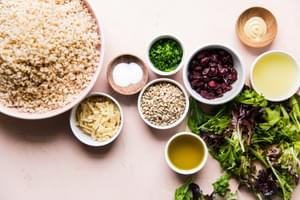 ingredients laid out for barley salad, dried cranberries, lettuce , lemon juice, chives, candied ginger