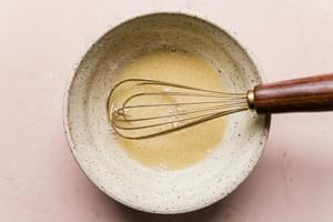 lemon chive vinaigrette in a bowl with a whisk