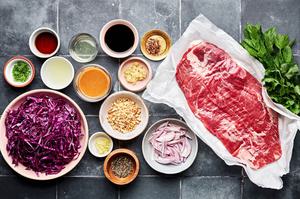 flank steak, red cabbage, mint, cilantro, shallots, roasted peanuts and thai dressing in prep bowls