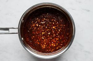 soy sauce, sesame oil, garlic, ginger, brown sugar, red pepper flakes and cornstarch cooking in a skillet