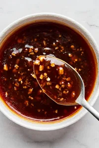 a dish of homemade stir fry sauce made with tamari, sesame oil, garlic, ginger, brown sugar, red pepper flakes and cornstarch