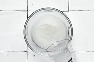 simple syrup being made by dissolving equal parts sugar in warm water