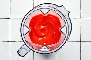 strawberry margarita in a blender made with lime juice, simple syrup, strawberries, tequila, and orange liquor