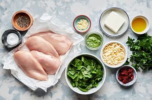 4 raw chicken breasts, cream cheese, pesto, mozzarella, sun dried tomatoes, spinach, salt, pepper and olive oil in prep bowls