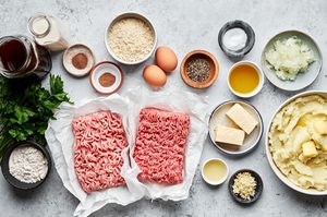 Ingredients to make Swedish meatballs with a creamy rich brown gravy arranged on a countertop