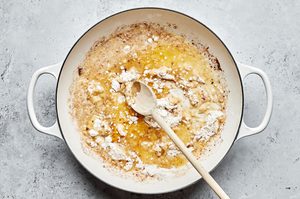butter and flour being stirred in a pan to make creamy gravy for easy homemade swedish meatballs