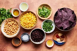 corn, black beans, chickpeas, Cilantro, Scallions, Spices, Poblano pepper, honey, limes and olive oil in prep bowls