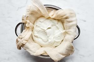 yogurt being strained in cheese cloth