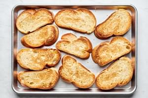 toasted challah bread on a baking sheet