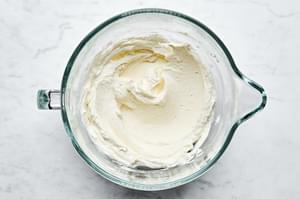 drained mascarpone and greek yogurt whipped together in a glass bowl