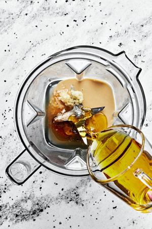 olive oil, tahini, apple cider vinegar, salt, sesame oil, honey, ginger powder, garlic & water in a blender
