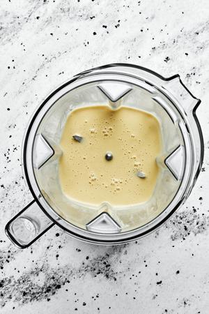 homemade tahini dressing in a blender made with tahini, olive oil, apple cider vinegar, sesame oil, honey, garlic & spices