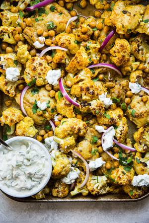 Tandoori Chicken Sheet Pan dinner with cauliflower, and chickpeas served with a bowl of Raita