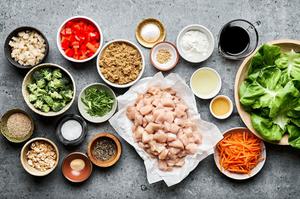 chicken thighs, spices, broccoli, red pepper, cornstarch, tamari, honey, carrots, water chestnuts, lettuce & cashews in bowls