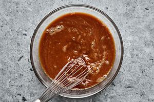 cornstarch slurry, brown sugar, soy sauce, honey, ginger, and garlic powder being whisked together in a bowl